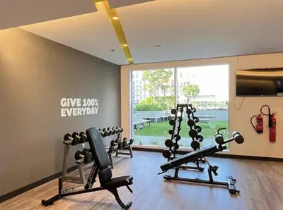 a gym with two treadmills and cardio machines at Luxurious 1BR Apartment with Creek View in Dubai
