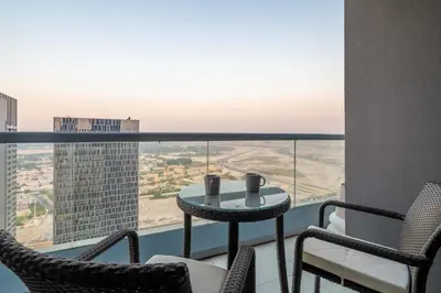 a balcony with a table and chairs and a view at GuestReady - Peaceful Skyline at Signature Tower in Dubai