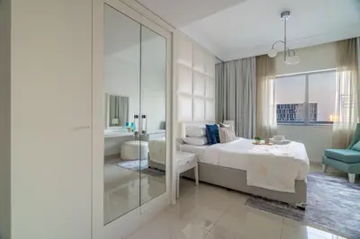 a bedroom with a king sized bed and a bathroom at GuestReady - Peaceful Skyline at Signature Tower in Dubai