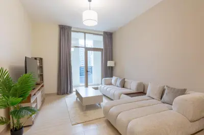 a living room with a couch and a tv at Premium Apartment, Right Infront of Canal in Dubai