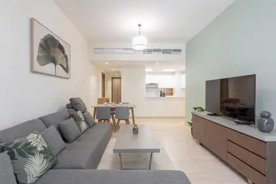 a living room with a couch and a tv at Partial Canal View, Business Bay in Dubai