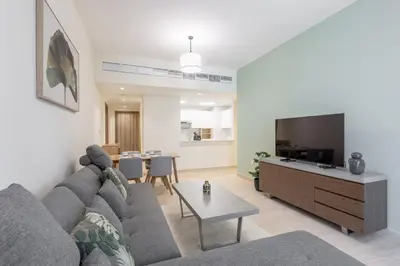 a living room with a couch and a tv at Partial Canal View, Business Bay in Dubai
