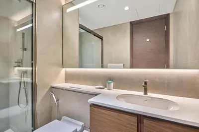 a bathroom with a sink and a toilet and a mirror at STAY BY LATINEM Luxury 1BR Holiday Home CVG 1410 Near Burj Khalifa in Dubai