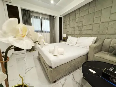 a hotel room with a bed and a chair at Modern & Stylish Studio Retreat in Dubai
