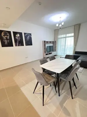 a dining room with a table and chairs at Bright 1BR Apartment in JVC - JLiving in Dubai