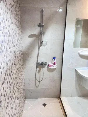 a bathroom with a shower and a sink at 1BR Apartment with Private Jacuzzi in JVC - JLiving in Dubai