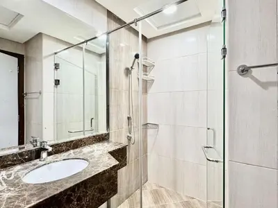 a bathroom with a sink and a glass shower at Homes2Retreat - Very Spacious Studio in the Heart of JVC in Dubai
