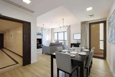 a dining room and living room with a table and chairs at Livbnb-Serene 2B with Marina and Sea View Walk to Beach in Dubai