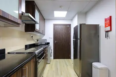 a kitchen with a stainless steel refrigerator and a door at Livbnb-Serene 2B with Marina and Sea View Walk to Beach in Dubai