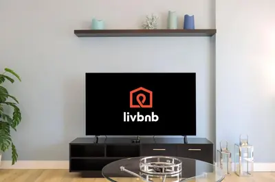 a living room with a tv on a table at Livbnb-Serene 2B with Marina and Sea View Walk to Beach in Dubai