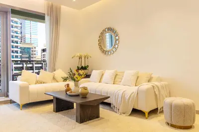 a living room with a couch and a table at Luxurious 2Bed in Sparkle Tower-Marina View in Dubai