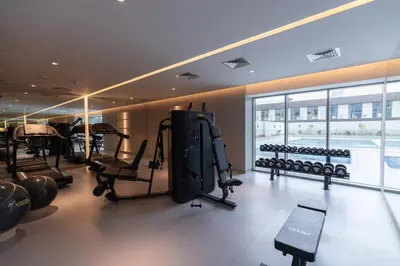 a gym with treadmills and exercise equipment in a building at Modern Studio in Condor Concept7, JVC in Dubai