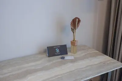 a table with a book and a broom on it at Modern Studio in Condor Concept7, JVC in Dubai