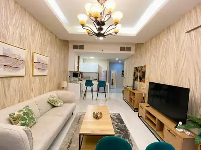 a living room with a couch and a television at Dubai Luxury Apartments In a good place in Dubai