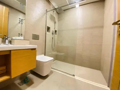 a bathroom with a shower and a toilet and a sink at Dubai Luxury Apartments In a good place in Dubai