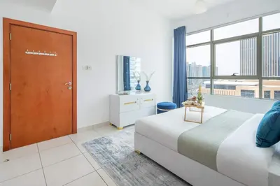 a bedroom with a bed and a large window at Frank Porter - Marina Views in Dubai
