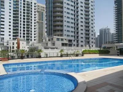 a large swimming pool in a city with tall buildings at Frank Porter - Marina Views in Dubai