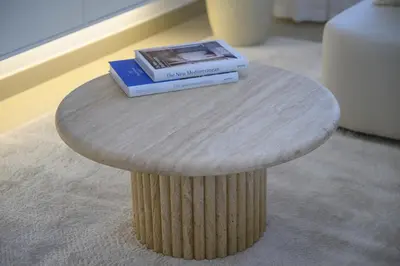 a book sitting on top of a round table at Luxury Apartment with Full Burj & Fountain Views in Dubai