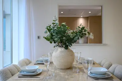 a table with a vase with a plant in it at Luxury Apartment with Full Burj & Fountain Views in Dubai