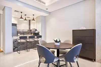 a dining room with a table and chairs at Two Bedroom Apartment in Nobles Tower by The S Holiday Homes in Dubai