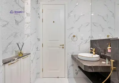 a white bathroom with a sink and a counter at Dream Inn - Modern 1BR in Arjan in Dubai