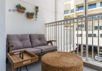a living room with a couch and a table at Dream Inn - Modern 1BR in Arjan in Dubai