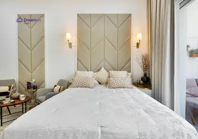 a bedroom with a large white bed with pillows at Dream Inn - Modern 1BR in Arjan in Dubai