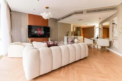a living room with a large white couch at Stylish 2Bedroom in DIFC Dubai Newly Furnished in Dubai