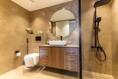 a bathroom with a sink and a shower with a mirror at Stylish 2Bedroom in DIFC Dubai Newly Furnished in Dubai