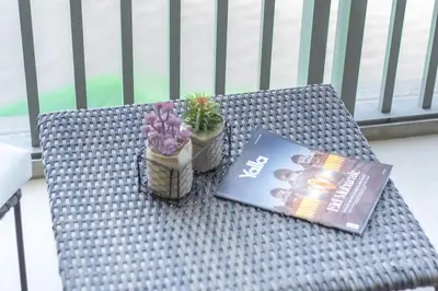 a book and flowers sitting on a wicker table at StayShort - Elegant 2BR in Dubai Marina - Luxury Awaits You in Dubai