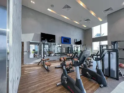 a gym with treadmills and ellipticals in a room at StayShort - Elegant 2BR in Dubai Marina - Luxury Awaits You in Dubai
