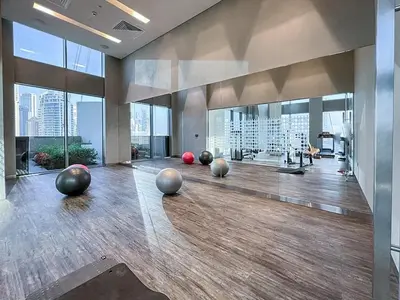 a gym with several balls on the floor in a room with windows at StayShort - Elegant 2BR in Dubai Marina - Luxury Awaits You in Dubai