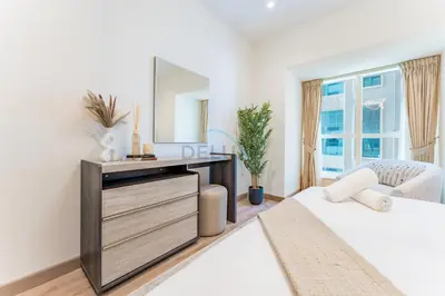 a bedroom with a dressing table and a mirror at Renovated 1BR with Partial Sea and City Views Near Beach, Elite Residence, Dubai Marina by Deluxe Holiday Homes in Dubai