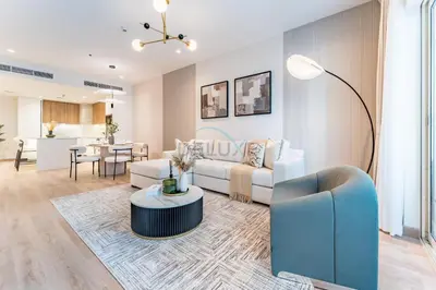a living room with a couch and a table at Renovated 1BR with Partial Sea and City Views Near Beach, Elite Residence, Dubai Marina by Deluxe Holiday Homes in Dubai