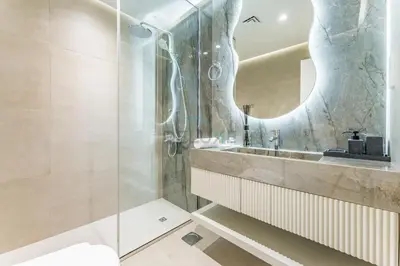 a bathroom with a sink and a mirror at Renovated 1BR with Partial Sea and City Views Near Beach, Elite Residence, Dubai Marina by Deluxe Holiday Homes in Dubai