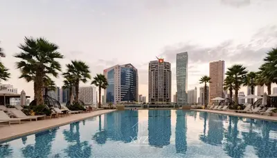 a swimming pool with a city skyline in the background at Luxury & Modern studio near Burj Khalifa in Dubai