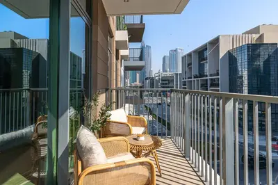 a balcony with chairs and a table on a building at Chic 1BR APT with Pool, Gym & Kid's Playground in Dubai