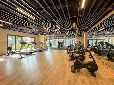 a gym with a bunch of treadms and cardio machines at Chic 1BR APT with Pool, Gym & Kid's Playground in Dubai