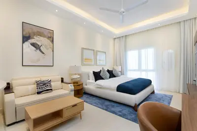 a living room with a bed and a couch at Renovated Studios in Nature at Discovery Gardens in Dubai