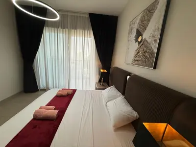 a bedroom with a bed with two towels on it at Sparkle Towers by Swarovski - Dubai Marina - High Floor - Beach Resort Sunset view in Dubai