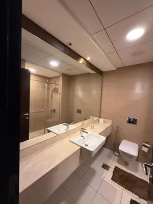a bathroom with a sink and a toilet and a mirror at Sparkle Towers by Swarovski - Dubai Marina - High Floor - Beach Resort Sunset view in Dubai