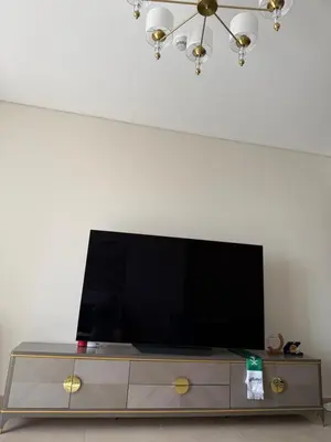 a flat screen tv sitting on top of a entertainment center at Sparkle Towers by Swarovski - Dubai Marina - High Floor - Beach Resort Sunset view in Dubai