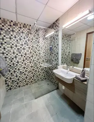 a bathroom with a sink and a mirror at Vibrant studio - 15m to marina in Dubai