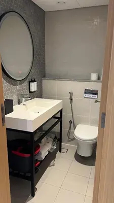 a bathroom with a sink and a toilet at Private Apartment in Novotel JVT Comfort for 4 Guests in Dubai
