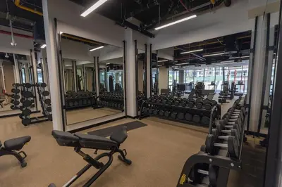 a gym with rows of chairs and mirrors at Stunning Studio in Peninsula Five in Dubai