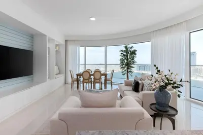 a living room with couches and a dining room at Maison Privee - Waterfront Living with Unparalleled Sea & Palm Vws in Dubai