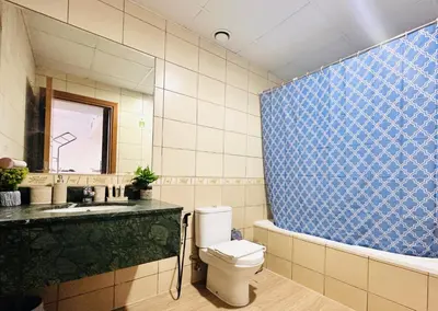 a bathroom with a toilet and a sink and a mirror at Airvistas Elevate Living 1BHK in Dubai