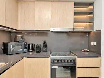 a kitchen with a stove and a microwave at Stylish 3BR in BurjCrown Balcony & HighEnd Comfort in Dubai