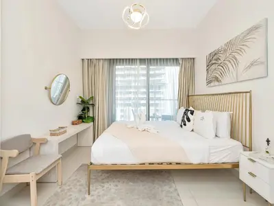 a white bedroom with a large bed and a window at Stylish 3BR in BurjCrown Balcony & HighEnd Comfort in Dubai