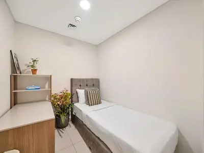 a white room with two beds and a shelf at Stylish 3BR in BurjCrown Balcony & HighEnd Comfort in Dubai